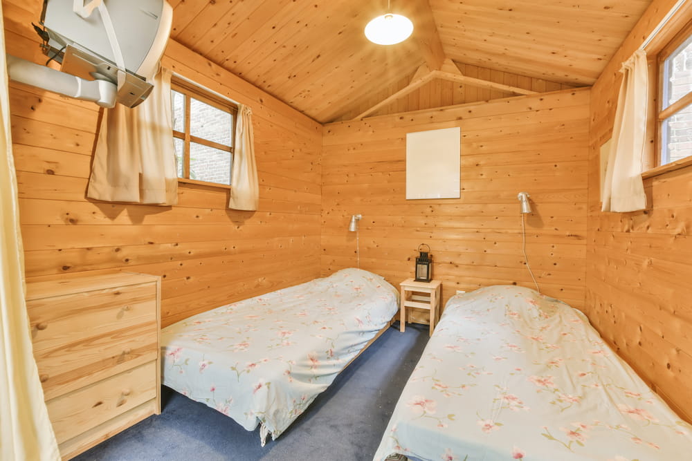 cozy-bedroom-with-rustic-wooden-walls-and-decor-2026-03-18-12-11-22-utc.jpg